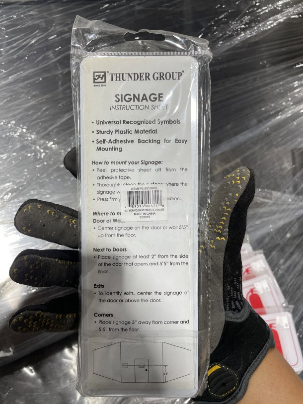 Brand new Thunder Group fire extinguisher signage instruction sheet in packaging; details on self-adhesive backing.