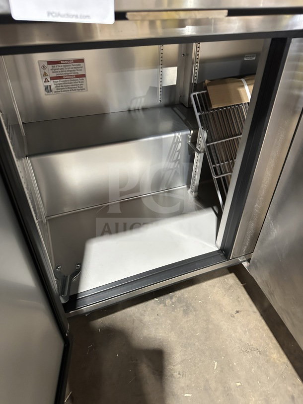 True TUC-72-HC 3-Door Undercounter Refrigerator, stainless steel, poly-coated rack, new condition, 115V, on casters.