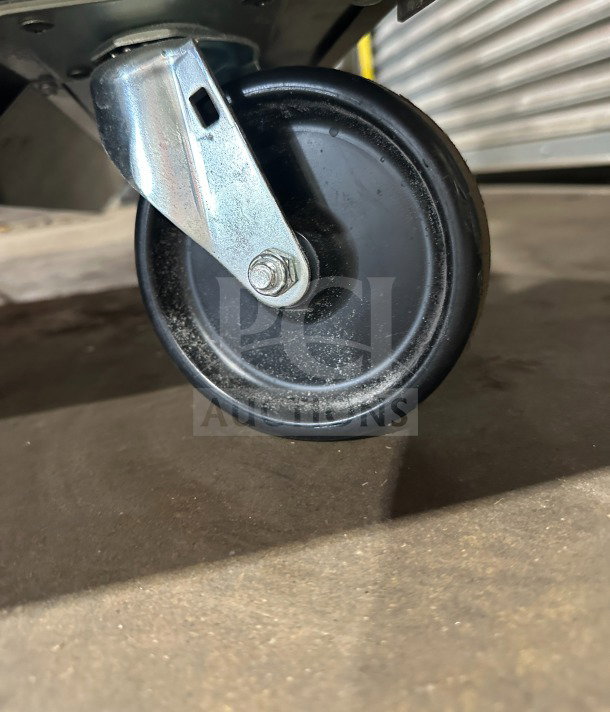 Caster wheel of a True TUC-72-HC commercial refrigerator, indicating mobility and durability in the design.