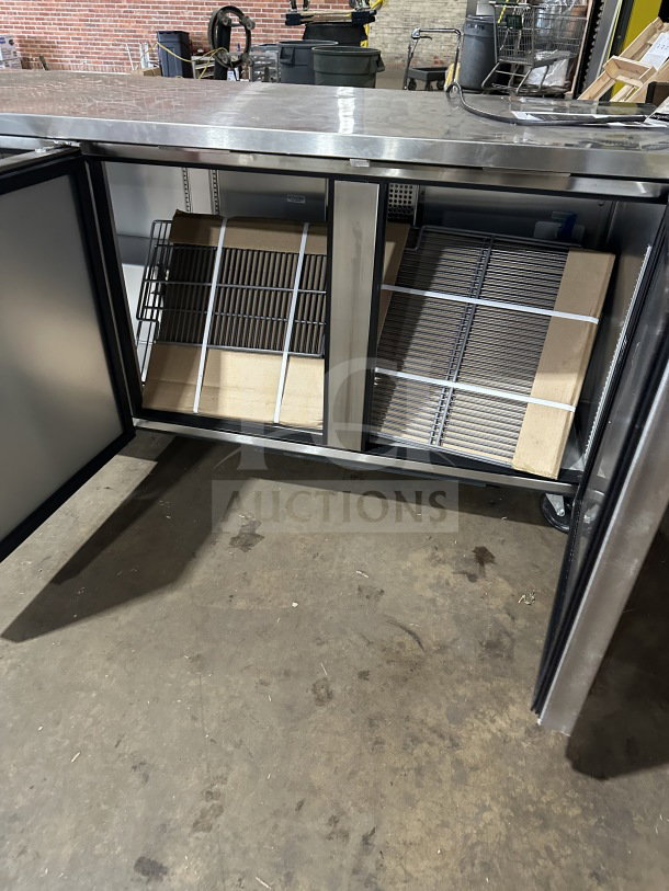 True TUC-72-HC stainless steel 3-door undercounter refrigerator, new, with poly-coated wired racks, on casters.