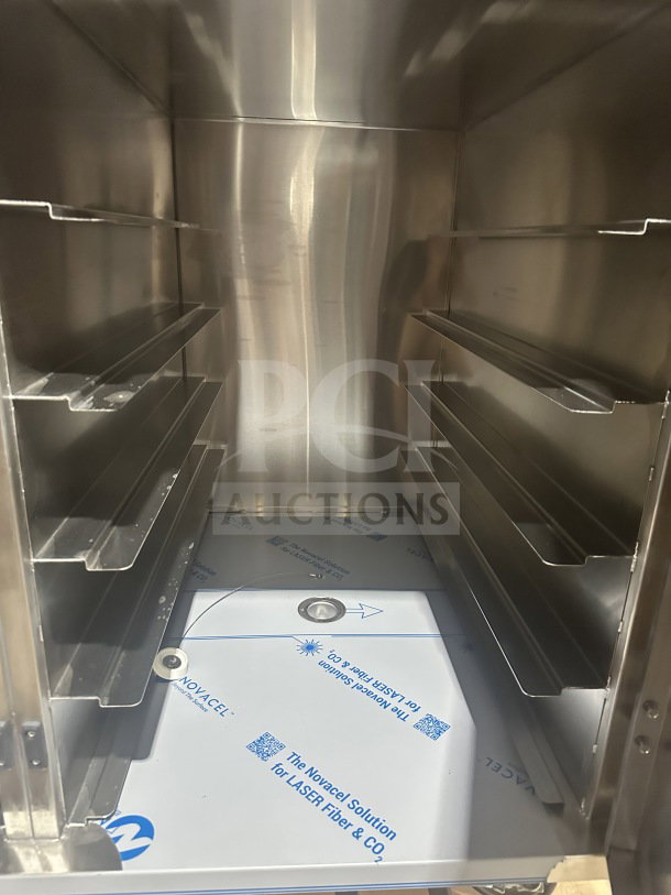 Brand new Dinex DXPICT202D stainless steel meal cart with 24 tray capacity, built-in pan slides, and casters.