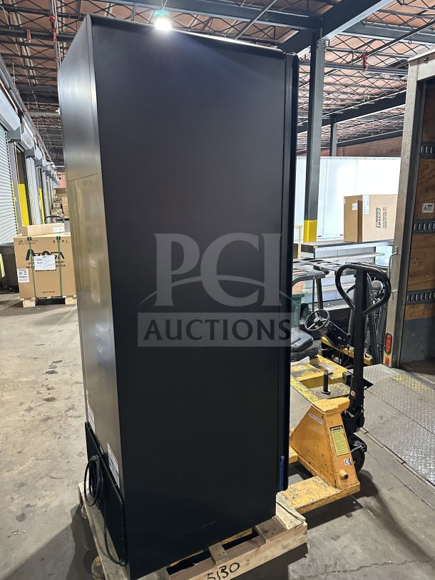 New True CVM-24-HC-EGC01 black refrigerated merchandiser with glass door and LED lighting, model CVM24HCEGC01, on pallet.