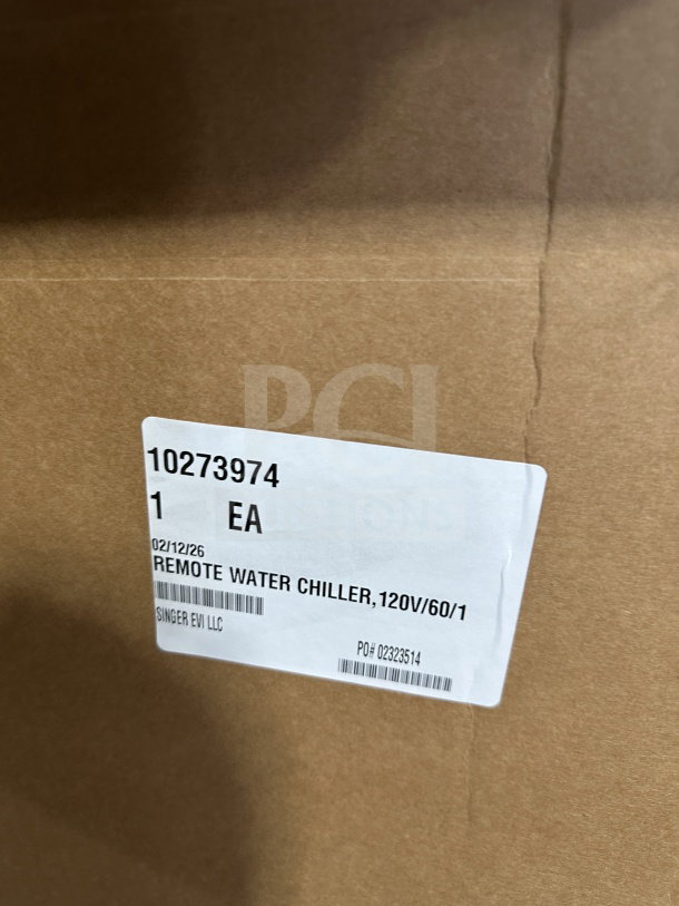 Brown cardboard box with a label reading "Remote Water Chiller, 120V/60/1, Singer EVI LLC, PO# 02323514, 1 EA."
