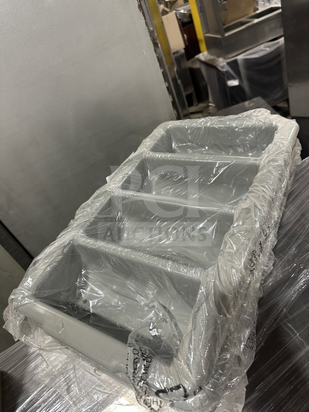 Brand new gray polyethylene 4-compartment cutlery box in shrink wrap, ideal for organizing flatware.