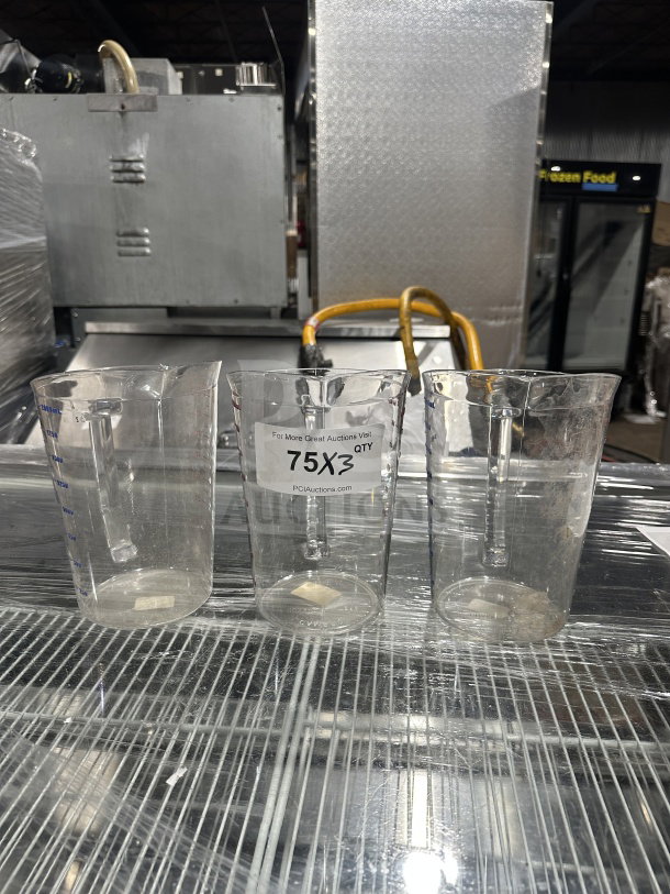 Three Cambro Camwear Series clear polycarbonate 2 Qt. measuring cups, Model 200MCCW, new condition with auction label.