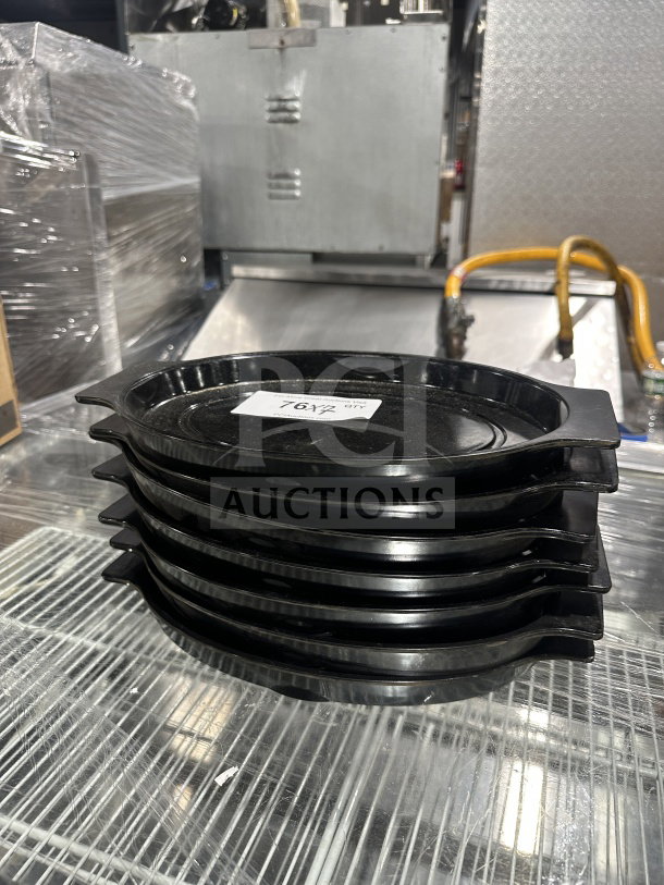 Stack of oval black Bakelite thermal underliners with handles, commercial use, auctioned at 7X bid. Label reads "7X 1/2".