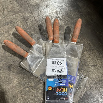 Winco TNH-42 stainless steel offset turner with orange Cool Heat handle, tags showing 3X bid offer. Brand new condition.
