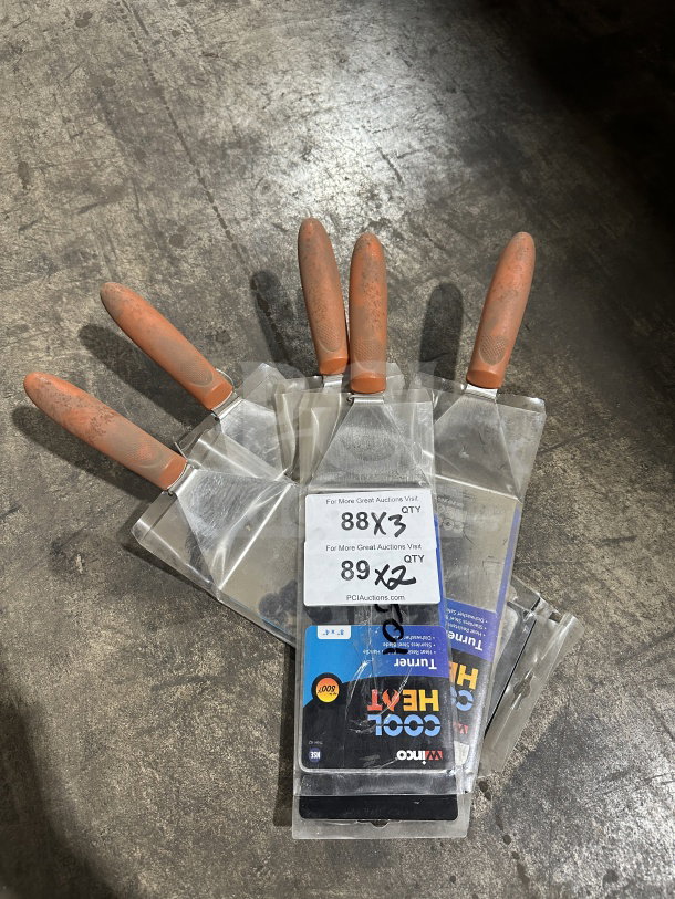 Winco TNH-42 8"x4" stainless steel offset turners with orange Cool Heat handles, brand new, multiple units shown.