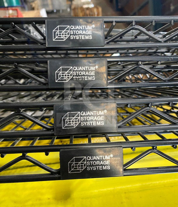 Quantum Commercial black wired shelf, carbon steel, 24x72", new condition, Quantum Storage Systems logo visible.
