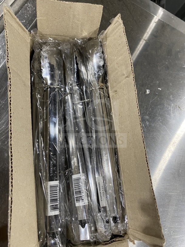 Brand new Stanton Trading 12" stainless steel utility tongs in box, labeled "Made in China," with barcodes visible.