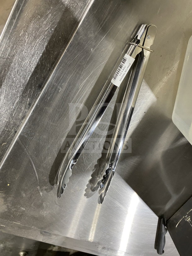 BRAND NEW Stanton Trading 12" Stainless Steel Utility Tong, heavy duty, with a locking mechanism, tagged with item details.