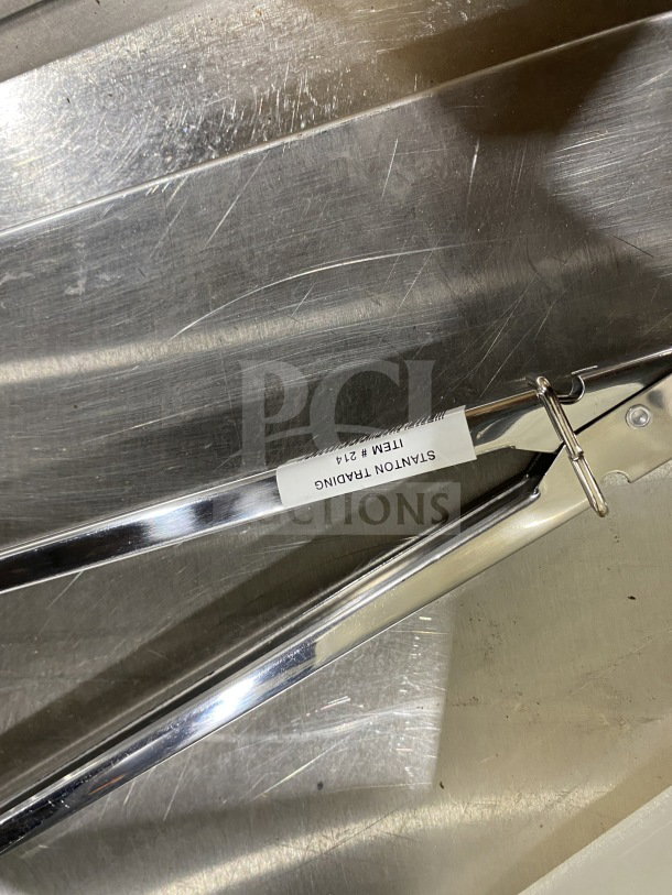Brand new Stanton Trading 12" stainless steel utility tong in box, heavy-duty, with item tag visible.