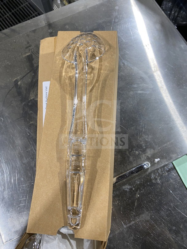 Brand new Cambro Camwear Series 13" clear perforated deli spoon, model SPOP13CW135, shown with packaging.