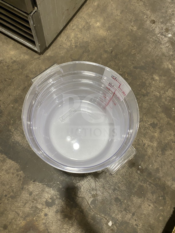Brand new 12 Qt. clear round polycarbonate food storage container with marked measurements; durable and stackable design.