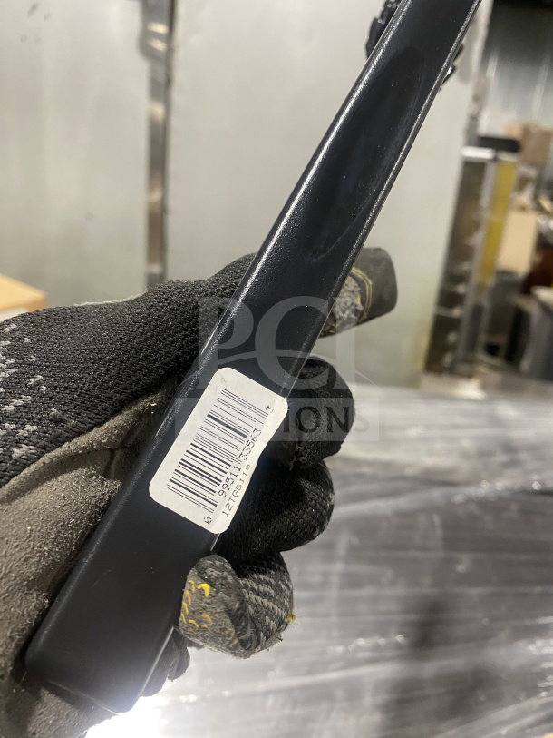 Brand new Cambro Lugano 12" flat-grip serving tongs, model 12TGS110, in black. Barcode and model label visible.