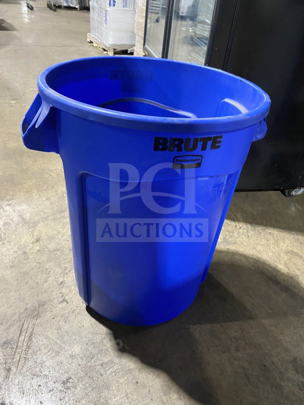 Brand new Rubbermaid BRUTE Series blue 32-gallon trash can, model FG263200BLUE, with durable construction and side handles.