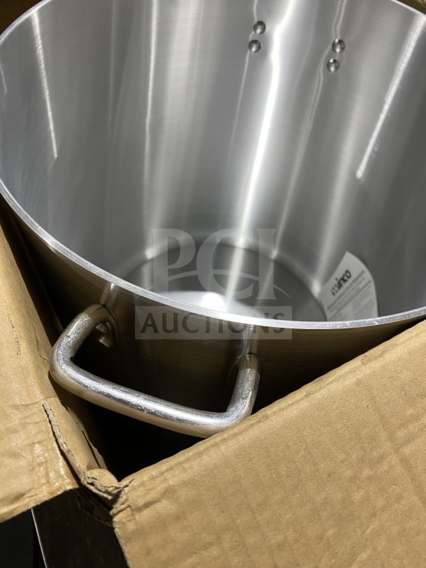 "Brand new Winco ALST-60 aluminum stockpot, 60 quarts, in box. Features sturdy handles, model and serial number visible."