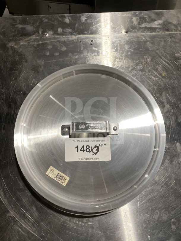 New Winco 32-Qt Aluminum Stock Pot Cover, Model AXS-32C. Features labels with model details and auction info.