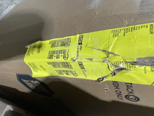 Yellow label on the Garland C18-1M-5001 box, indicating model and item numbers. Box shows signs of wear and tear.