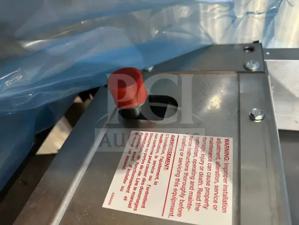 Alt text: Garland Model C18-1M-5001 18-inch gas griddle safety mechanism and warning label detail.