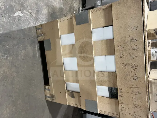 Brand new L&J 36" showcase display case in original packaging. Visible handwritten markings on the crate.