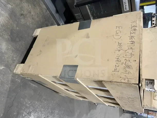 Brand new L&J 36" showcase/display case merchandiser in shipping crate, text on the box includes specifications and date.