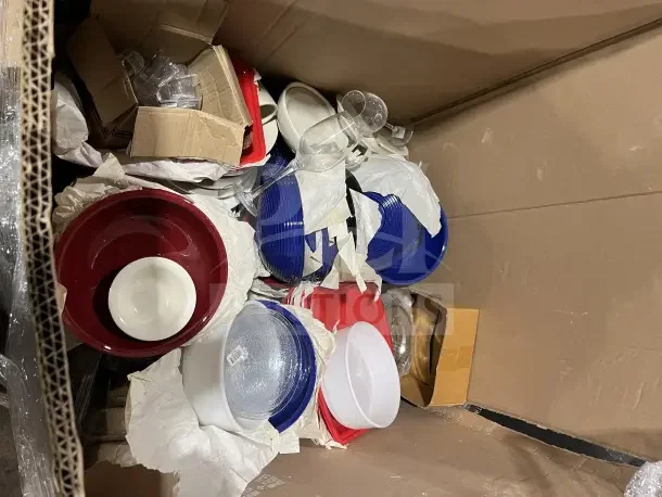 Large box filled with new dishware, cups, and poly bowls. Various colors and sizes. Includes wrapped items and boxes.