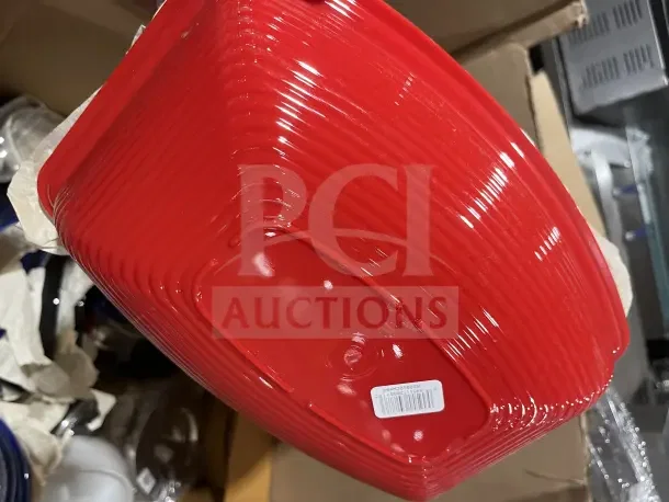 Large box filled with new dishware, cups, red poly bowls; visible barcode label on bowl.