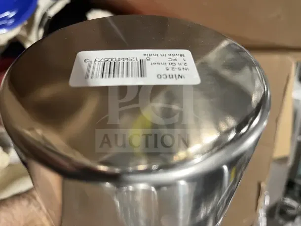 Large new box of dishware including mugs and poly bowls. Stainless steel item labeled "Winco INS-25" visible, made in India.
