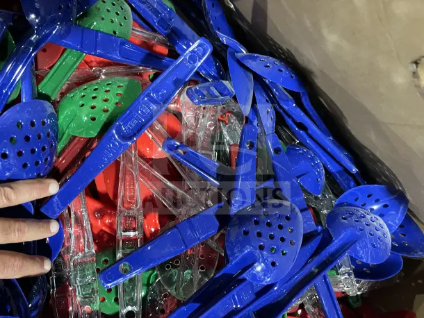 New assorted poly multi-color serving spoons and tongs, featuring vibrant blue, red, and green. Visible marking: "ALL ONE MONEY!"