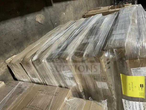 Pile of new Alpine ALP430BLK Universal Dispenser Stands on a pallet, wrapped in plastic. Boxes labeled and unopened.