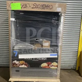 Brand new Ojeda ALPA-120H refrigerated open merchandiser with pull-down night curtain, wrapped and ready for display.
