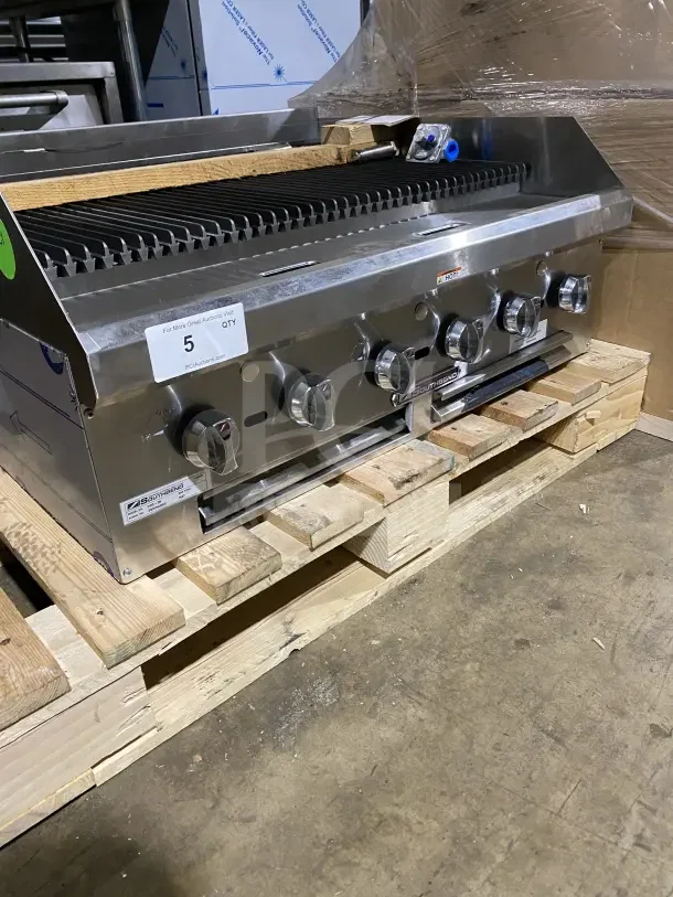Brand new Southbend HDC36 stainless steel gas char broiler with back and side splashes, on wooden pallet.