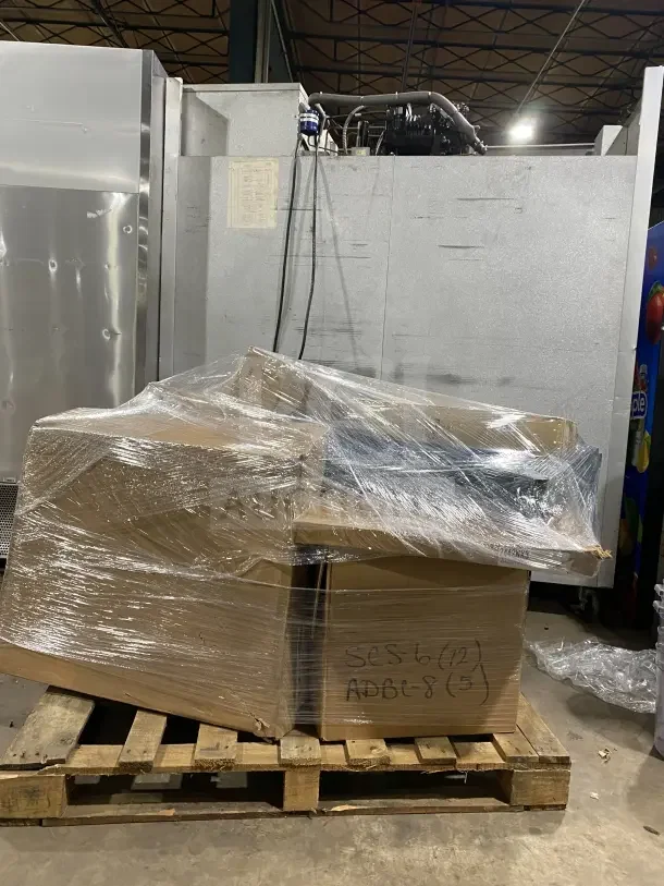 Mixed pallet with 6 AM bags, 5 chef pans, jackets, commercial casters, brooms, strainers, water filter, plates; wrapped and boxed.