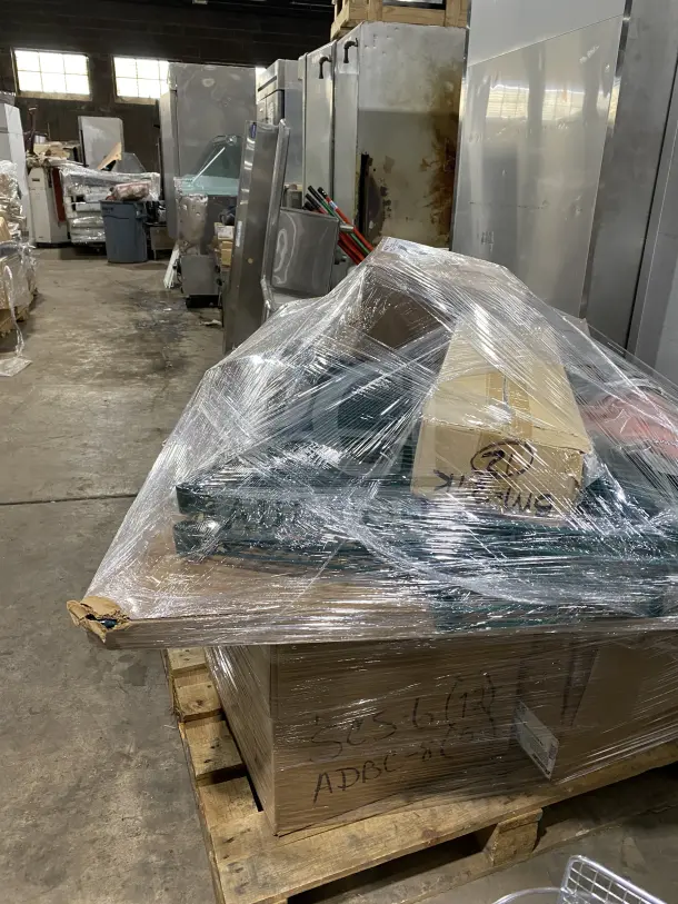 Sealed mixed pallet including AM bags, chef black pans, spice jackets, commercial casters, brooms, strainers, and more.