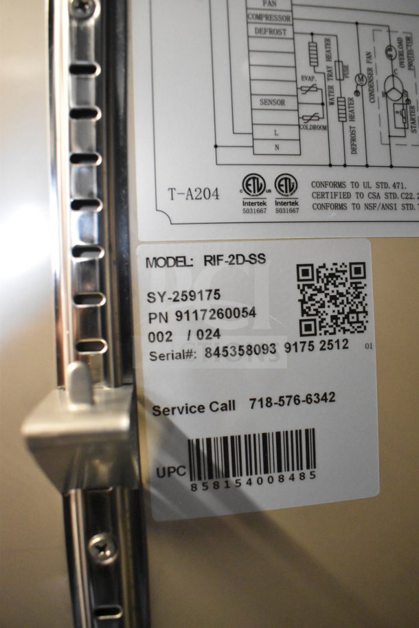 "2025 KoolMore RIF-2D-SS commercial reach-in freezer, brand new scratch and dent, model info and serial number visible."