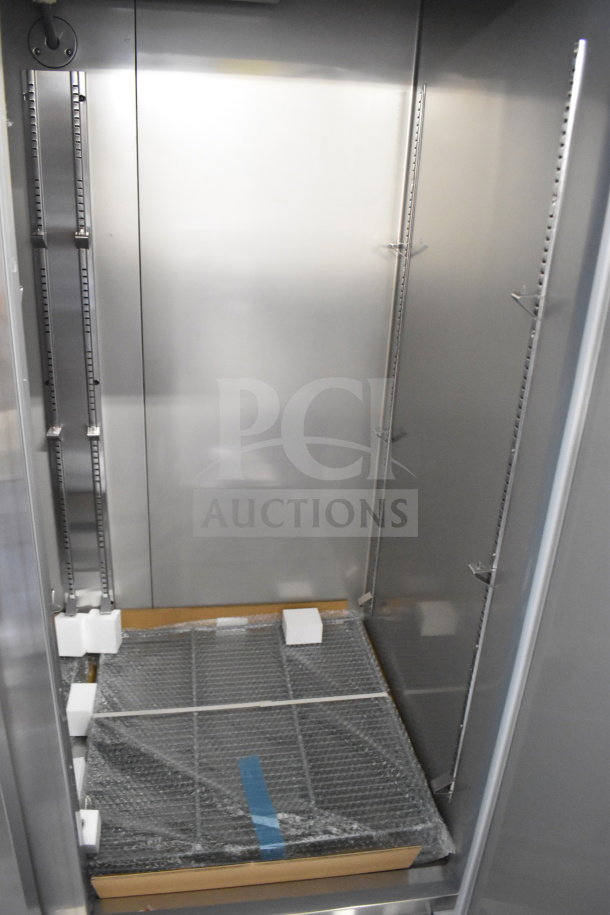 Brand new KoolMore RIR-2D-SS commercial 2-door reach-in cooler; 115 volts, 1 phase; interior view with shelves.