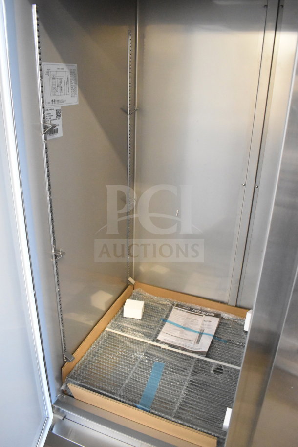 Brand new KoolMore RIR-2D-SS commercial cooler, 2-door model, 115V, 1 phase. Interior shown with shelving and manual.
