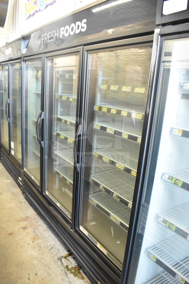 2016 True GDM-72-HC commercial 3-door reach-in cooler. Includes glass doors, shelving, and "Fresh Foods" signage. 115V, 1 phase.