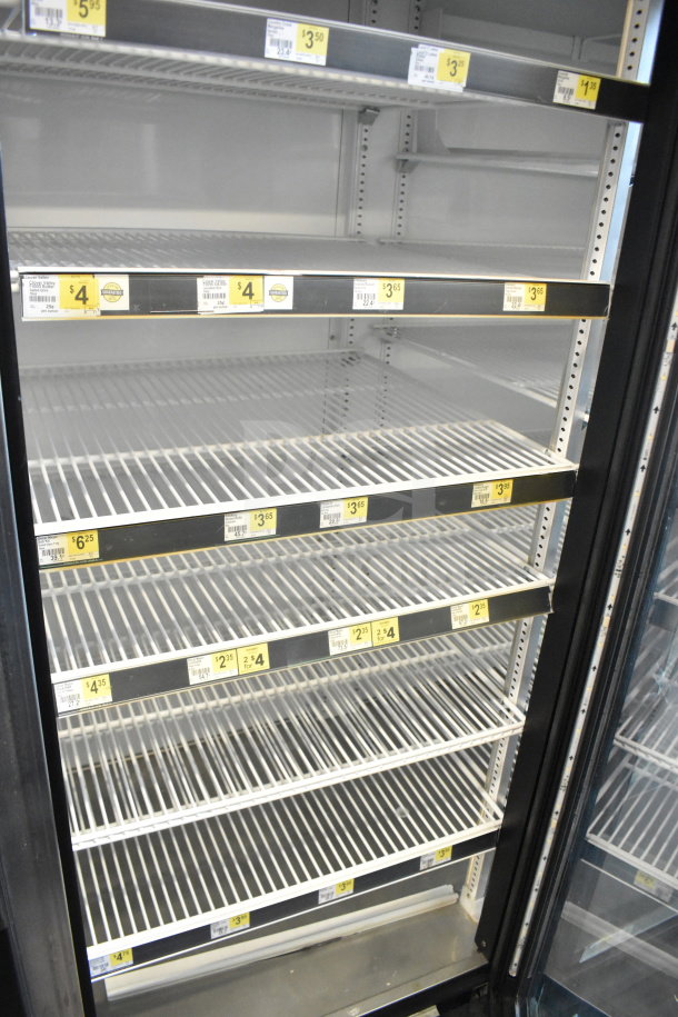 2016 True GDM-72-HC commercial 3-door reach-in cooler, empty shelves, price tags visible, 115 volts, 1 phase.