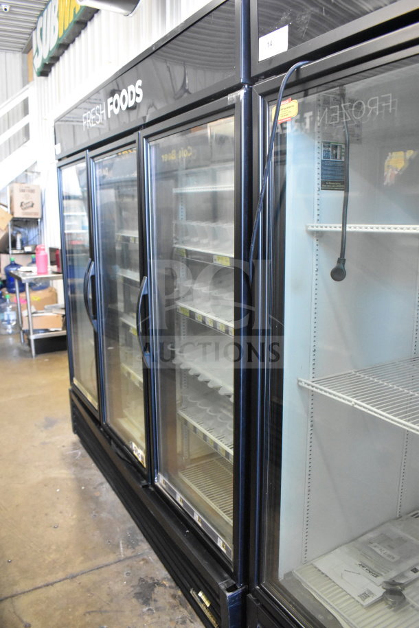 2016 True GDM-72-HC commercial cooler, 3 glass doors, reach-in, 115 volts, used condition, shelves inside, model label visible.