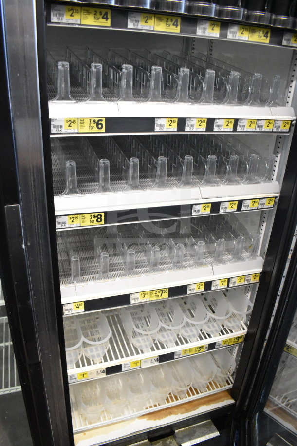 2016 True GDM-72-HC Commercial 3 Door Reach-In Cooler, empty shelves, price tags visible, good condition.