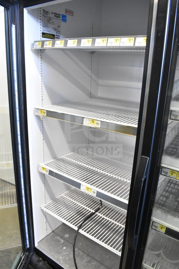 2016 True GDM-72-HC commercial 3-door reach-in cooler merchandiser, 115 volts, 1 phase, with metal shelves.