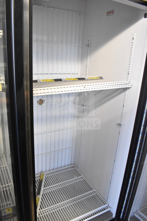 2016 True GDM-72F-HC commercial 3 door freezer merchandiser. Shelving visible, clean interior, label shows model.
