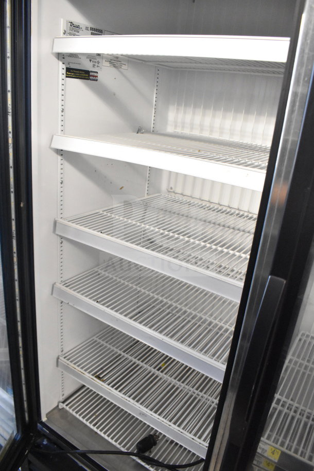 2016 True GDM-72F-HC 3-door commercial reach-in freezer with shelving, model and electrical specs visible, clean condition.