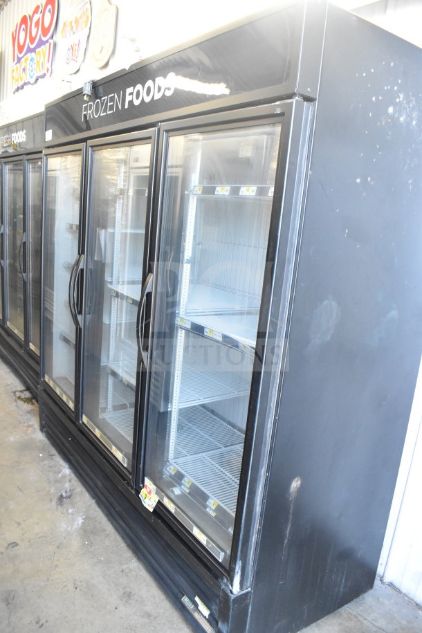 True GDM-72F-HC commercial 3-door reach-in freezer with glass doors, shelving, "Frozen Foods" label, 115/208-230V, 1 phase.
