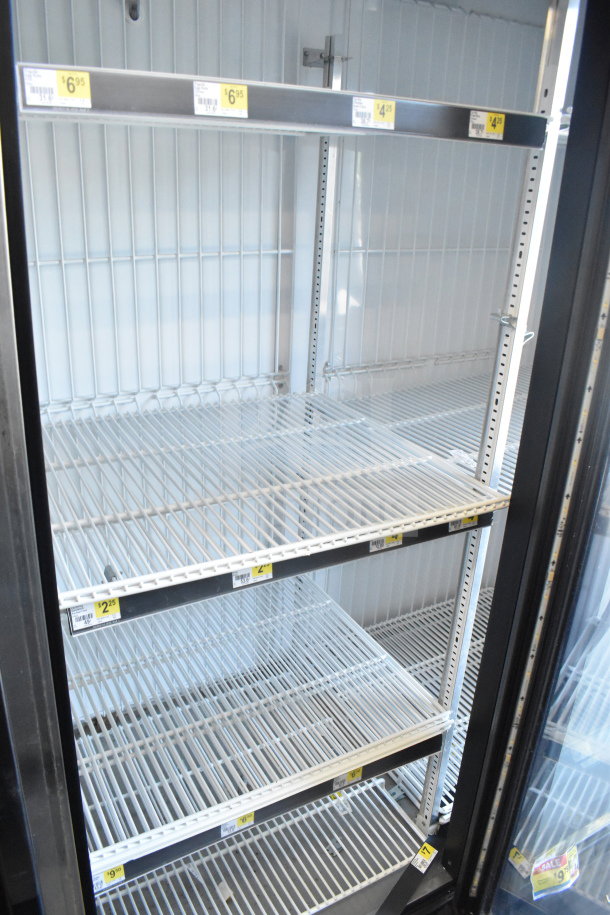 2016 True GDM-72F-HC commercial freezer, 3-door, white wire shelves, price tags visible, 115/208-230 volts, 1 phase.
