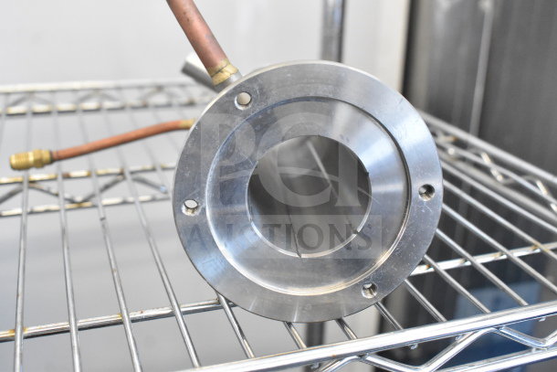 Avantco Ice 19430323 evaporator cylinder, new condition, visible copper connections, on metal shelf.