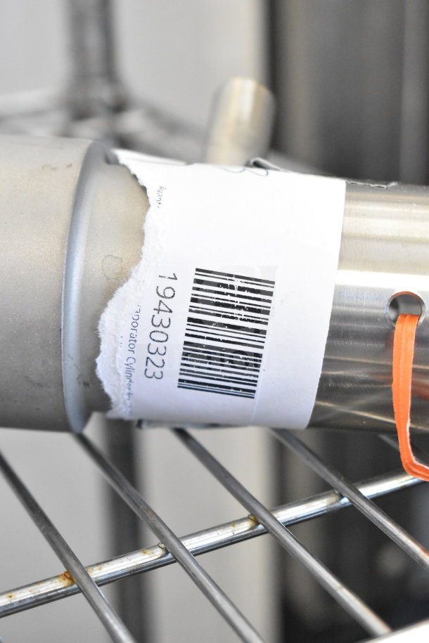 Avantco Ice Evaporator Cylinder model 19430323, new, with barcode visible, placed on metal shelving.