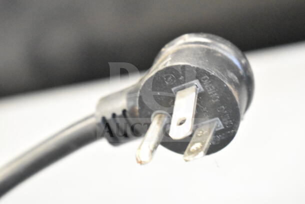 Close-up of a 115-volt power plug from the 2018 True GDM-12-HC Cooler Merchandiser. Black cord in good condition.